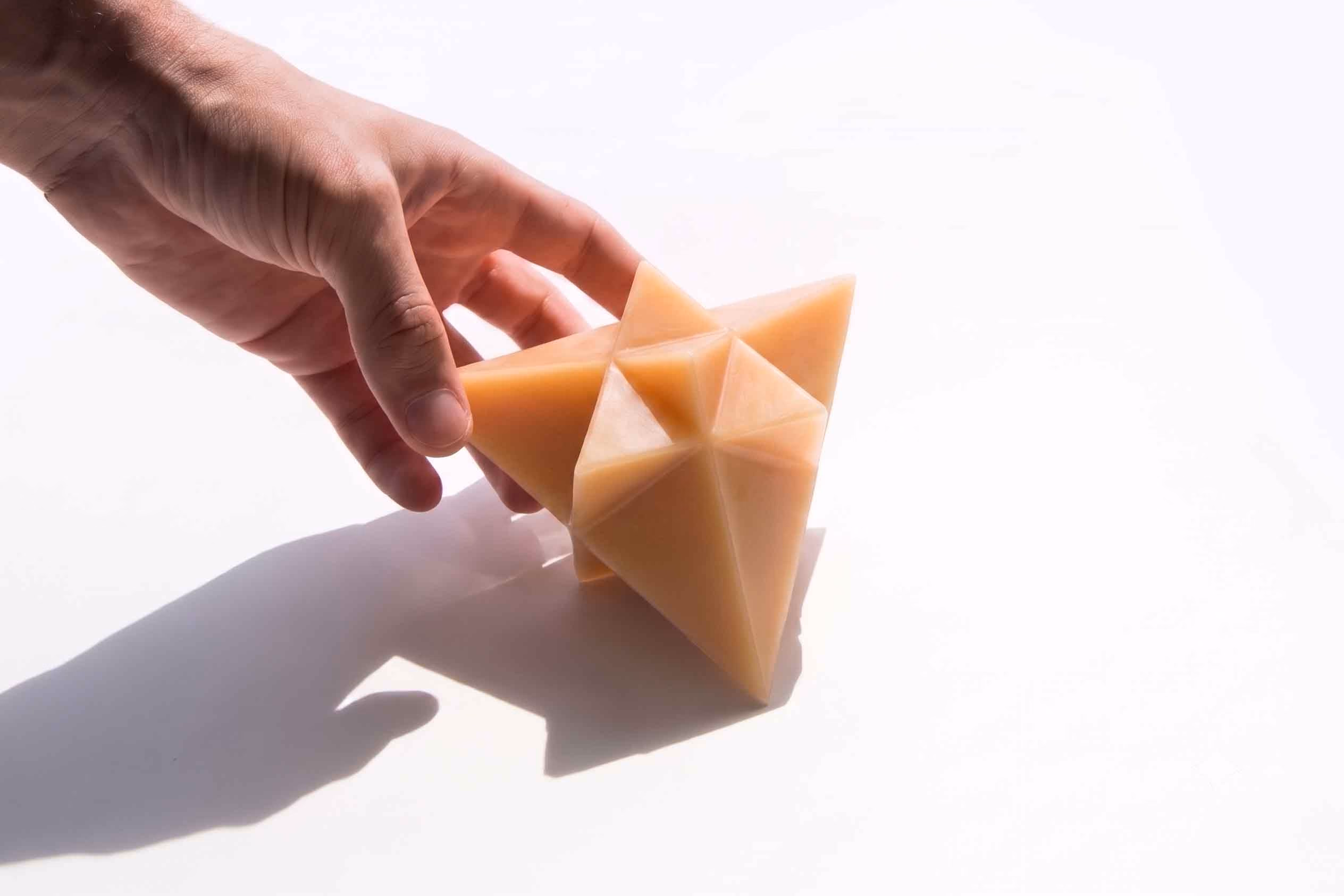 Tetrahedron: Wax cast in a faceted tetrahedral mold rather than a conventional rounded shape, each face of the mold leaving a sharp edge on the finished piece
